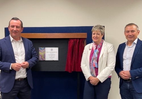 Mark McGowan, Ali Kent and Roger Cook stand in front of plaque 