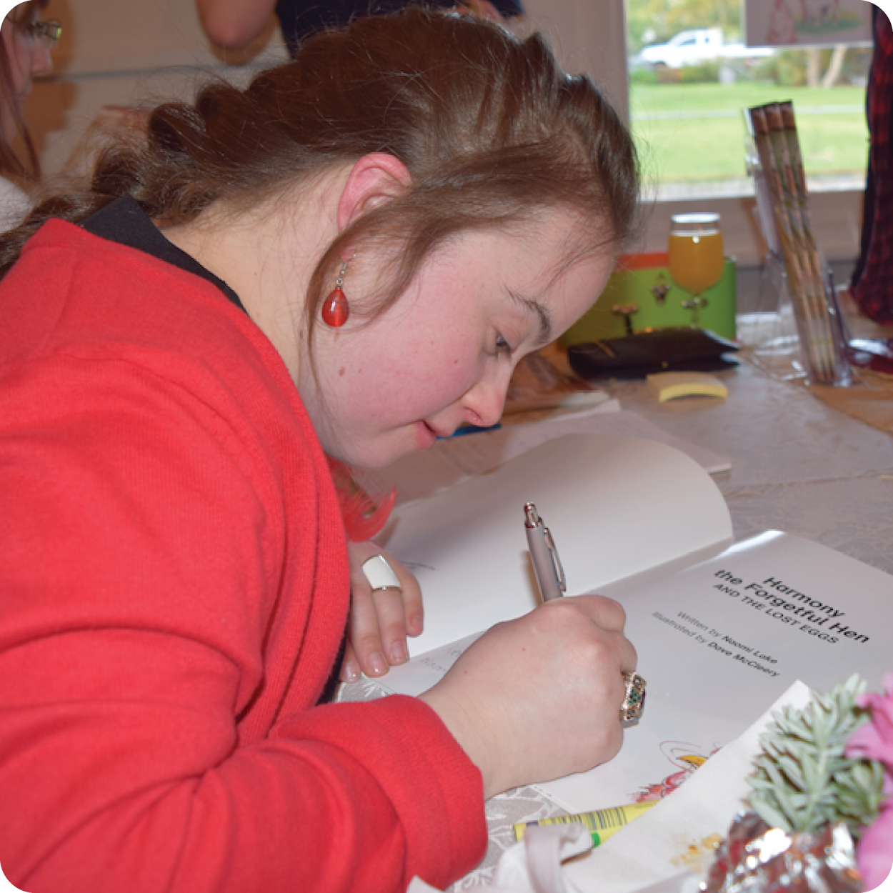 Guest speaker Naomi Lake pictured signing her book.