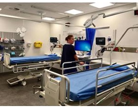 Clinician standing in the hospital ward.