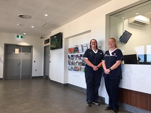 Two nurses standing in foyer.