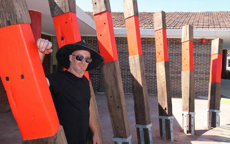 Artist Jahne Rees with his artwork at Collie Health Service