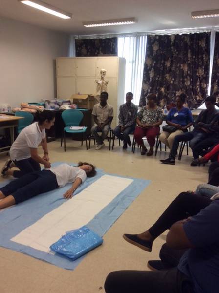 WACHS nurses Rhiann Gosper and Helen Guiness (on ground) demonstrate a log roll used to move people who have suffered trauma without causing further injury.