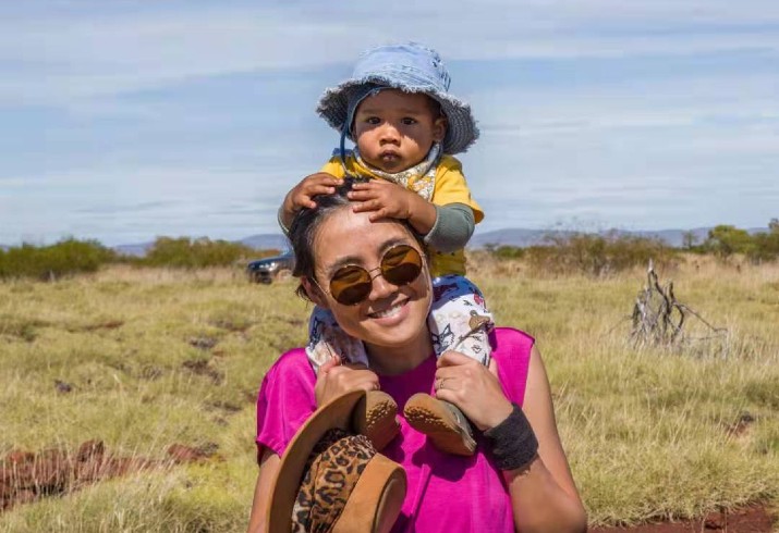 Dr Lucia Wand with child on her shoulders 