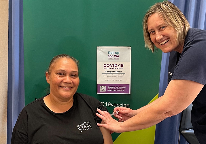 Photograph of Leah Umbagai as she receives her first COVID-19 vaccine