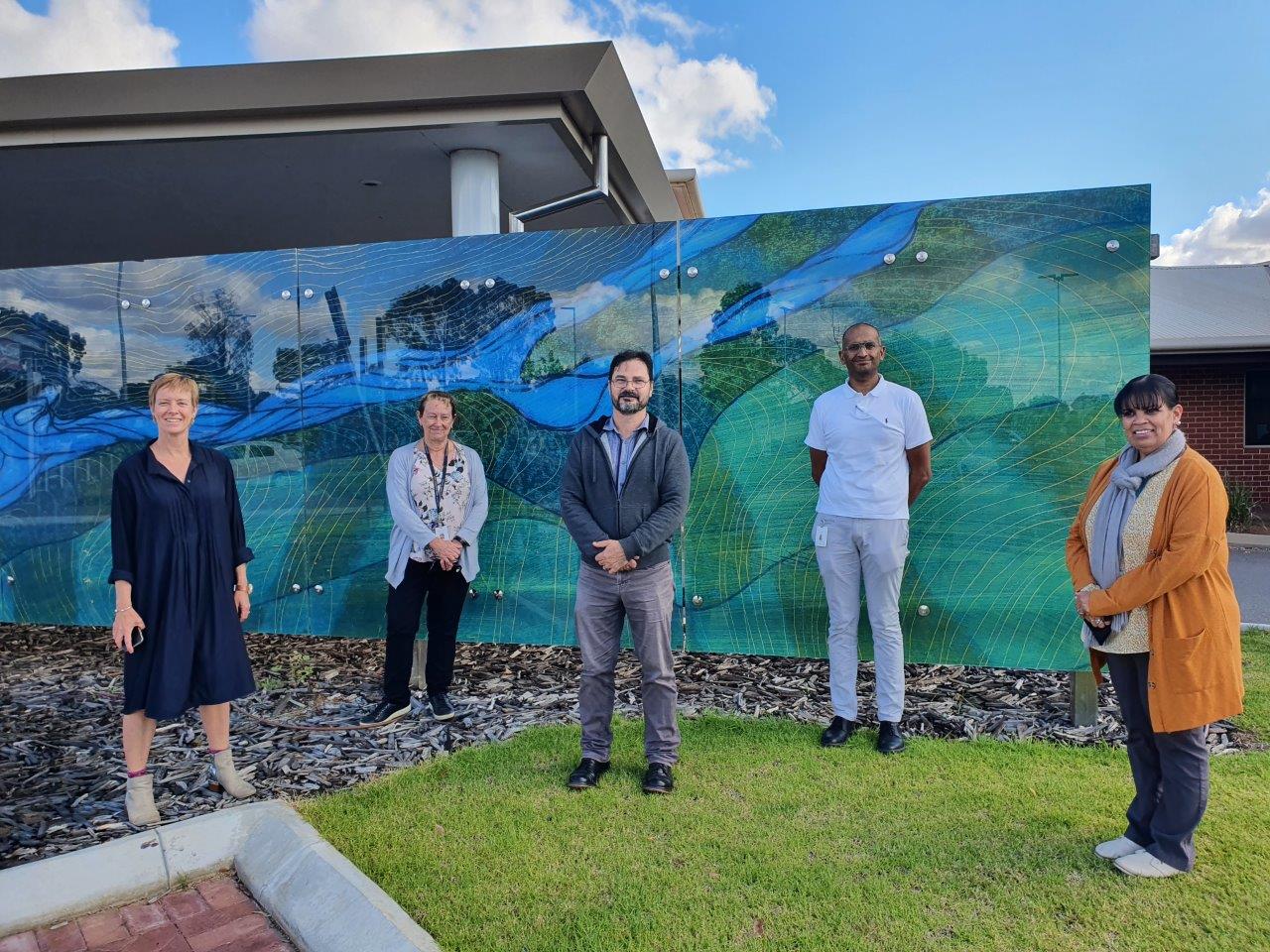 Five people standing for group photo.