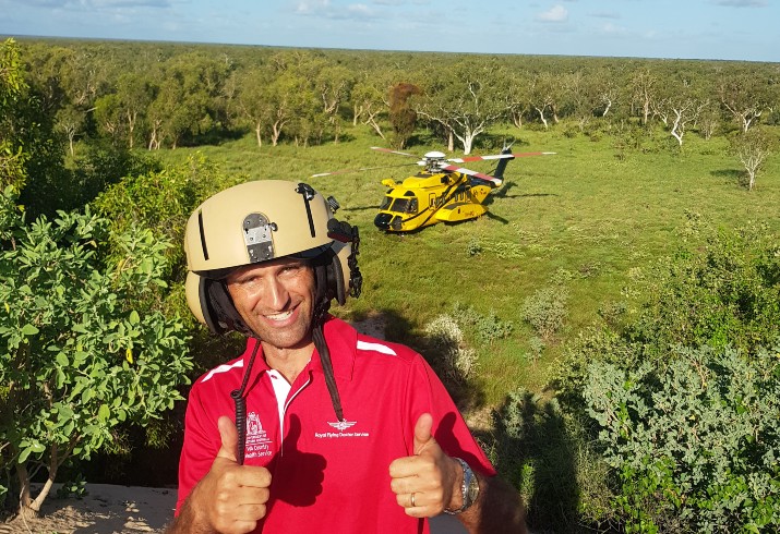 Dr Forster giving thumb up with RFDS helicopter 