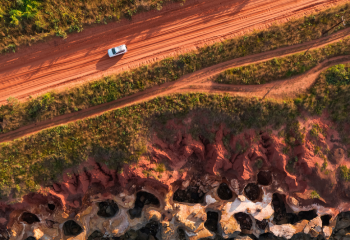 Car driving along a dirt road