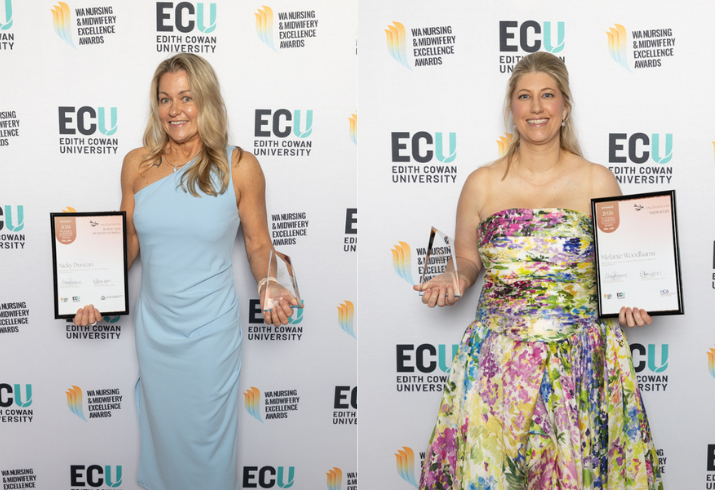 Two women in evening dress pose with their framed certificates and awards
