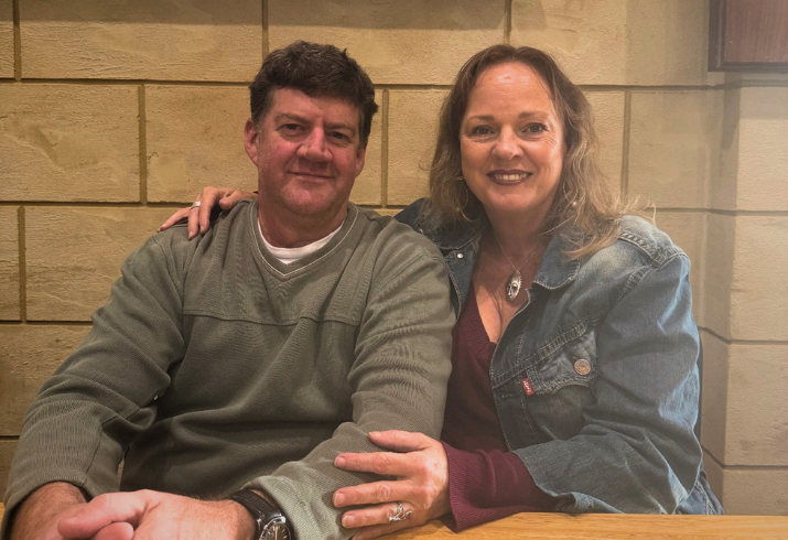 Man and woman sitting at table.