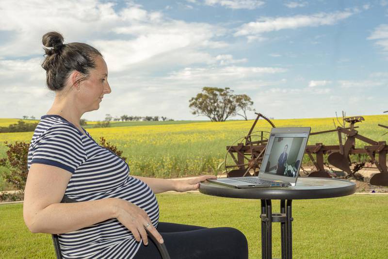 An expectant woman using the laptop
