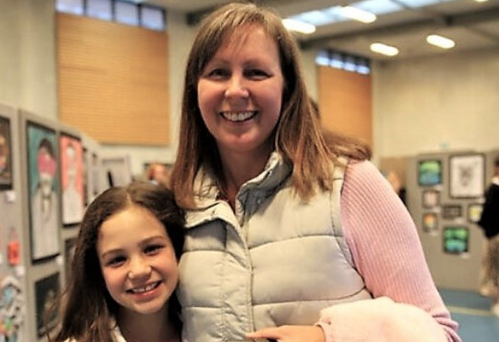 Doctor standing with daughter for a photo.